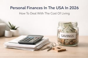 Personal finance concept in the USA showing a savings jar filled with US dollar bills and coins labeled “savings,” alongside a calculator on stacked bills, house-shaped keychain, and keys on a desk, representing budgeting, cost of living management, and financial planning in 2026.